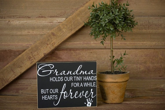 Grandmas hold our tiny hands for a little while, but our hearts forever sign