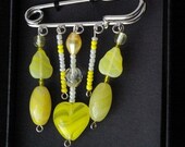 Sunny yellow kilt pin brooch.