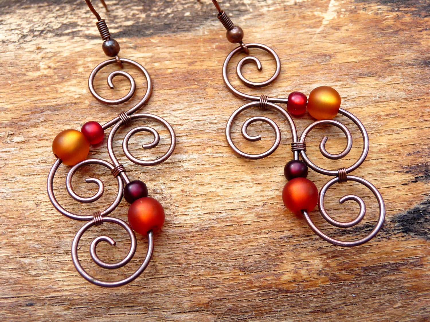 Earrings - Aotearoa - Copper & Polarisbeads ORANGE and RED - New Zealand Maori Symbols plafully wrapped out of oxidized copper wire