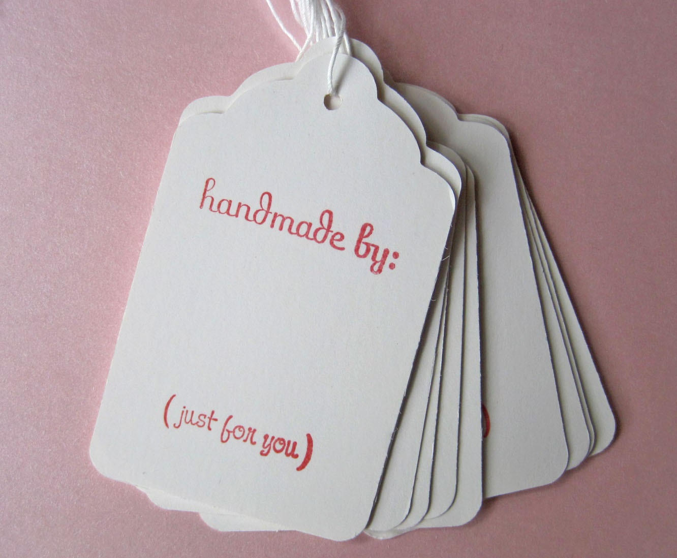 Set of 10 stamped tags with string -- "handmade by"