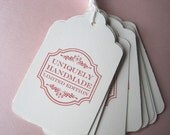 Set of 10 stamped tags with string -- "uniquely handmade"
