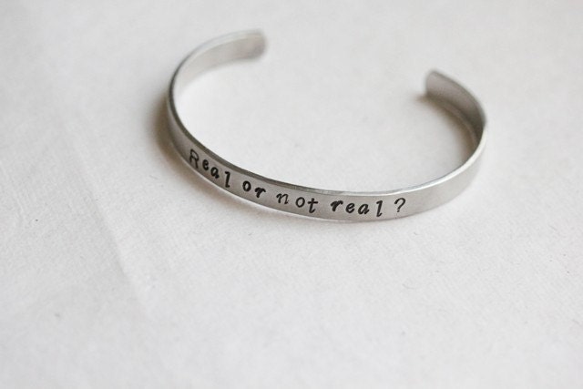 Hunger Games Real or Not Real hidden message cuff
