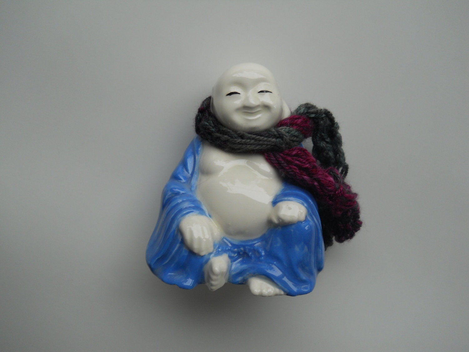 Everyone Needs A Scarf... Happy Buddha Bank with handknit scarf - found item with handknit accessory