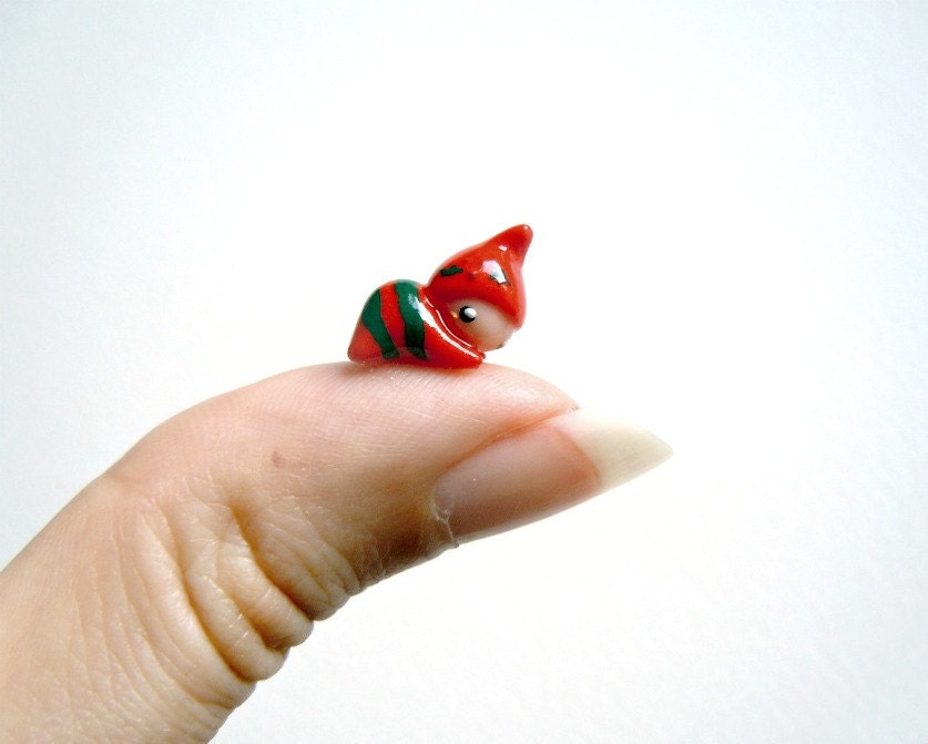 Tiny Christmas elf in red and green suit