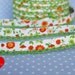 1 meter bias tape "flowers" in orange with lime green crochet lace