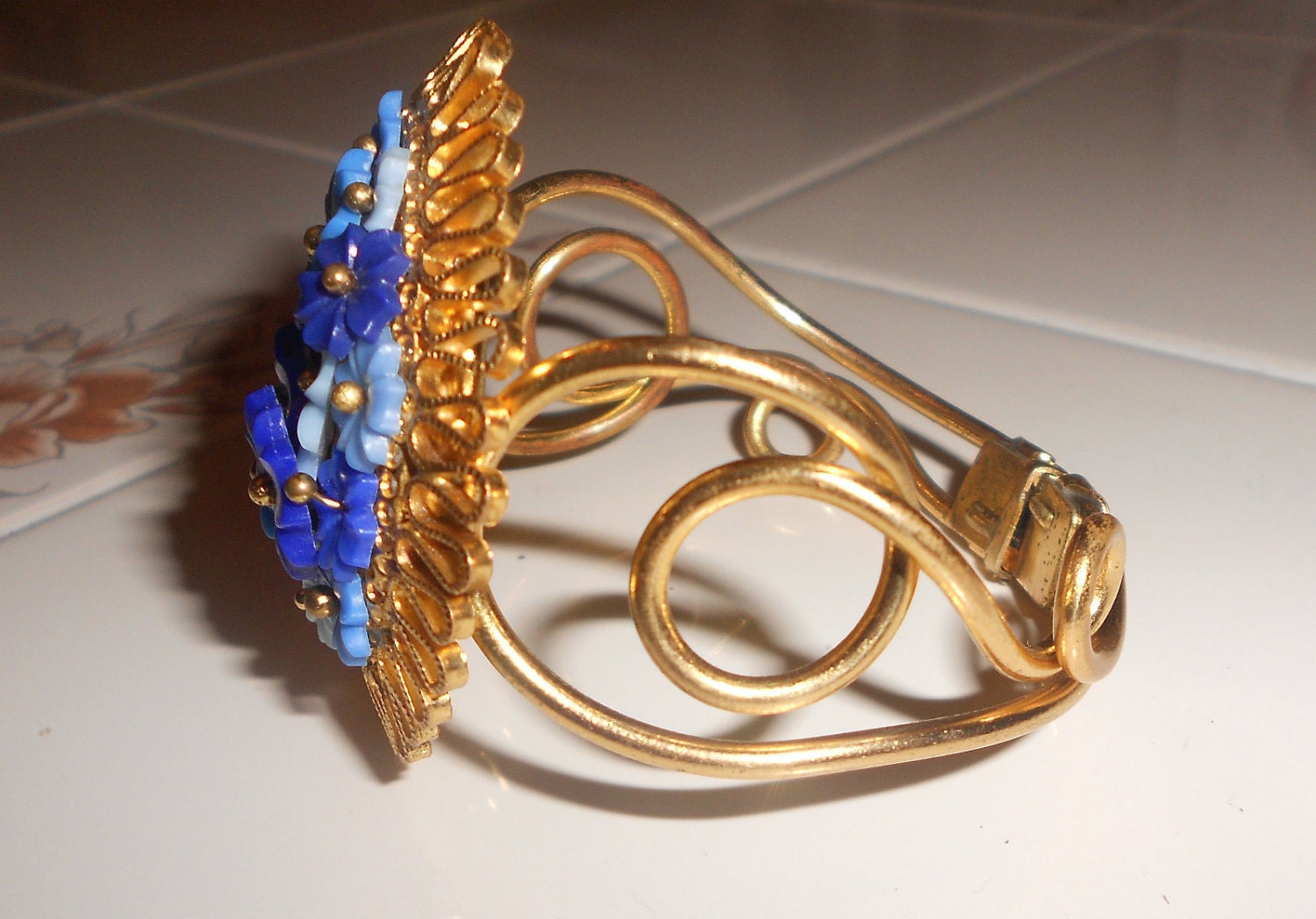 Vintage floral cuff hinged bracelet with celluloid blue flowers