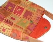 Medium handbag in colorful red orange upholstery fabric with zippered pocket