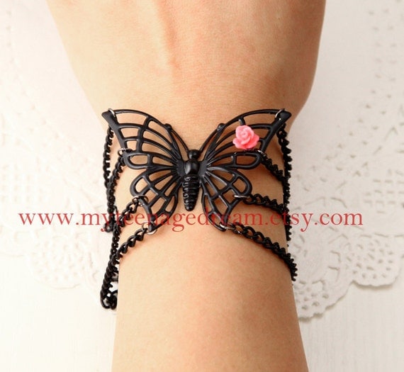 cool black butterfly bracelet, with a pink rose flower