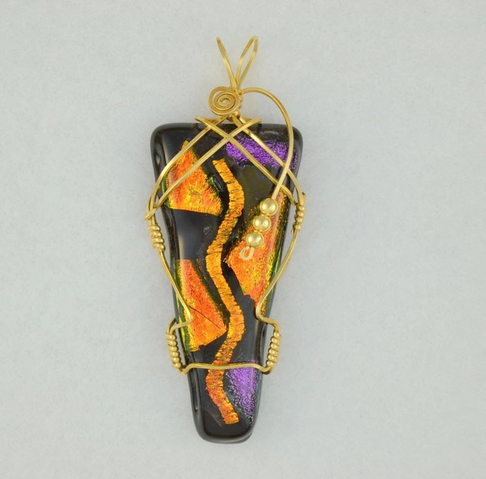 Wire wrapped dichroic glass pendant in 14K gold filled.   Unusual and unique