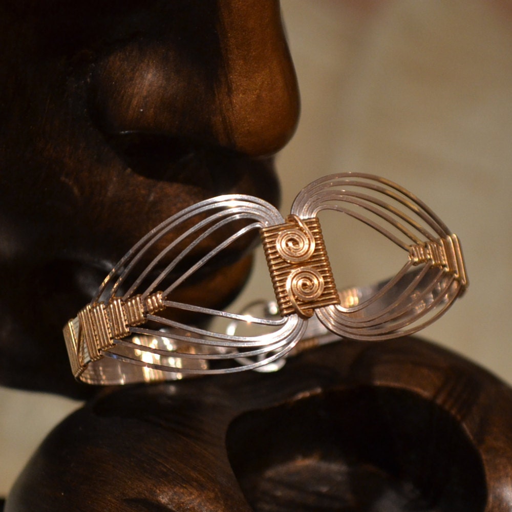 Egyptian wire wrapped Bracelet with a Twist.  Sterling Silver and 14K Gold filled. Size Small