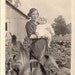 Vintage/ Antique Photo of a woman with a princess leia-ish hair holding a baby