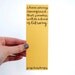 Yellow Bookmark with Handwritten Calligraphy . I Have Always Imagined That Paradise Will Be a Kind of Library