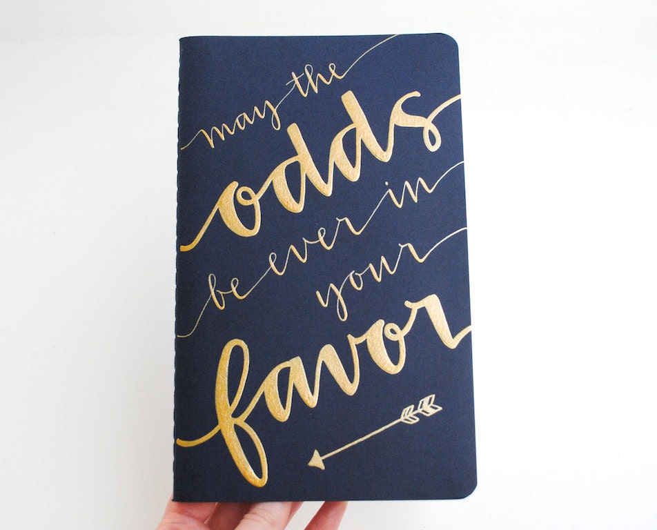 RESERVED Hunger Games Inspired Notebook . Large Navy Moleskine with Gold Ink Calligraphy . May the Odds Be Ever in Your Favor