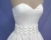 A 50s wedding or cocktail dress in white duchess satin