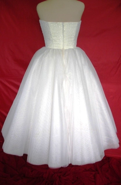 A 50s inspired wedding gown, intricately detailed corset cocktail dress