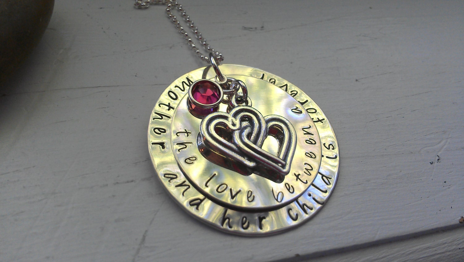 the love between a mother and her child is forever sterling handstamped necklace