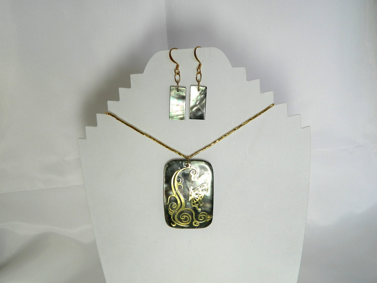 Black lip shell with gold inlay of butterfly and decorative swirls gold vermeil chain