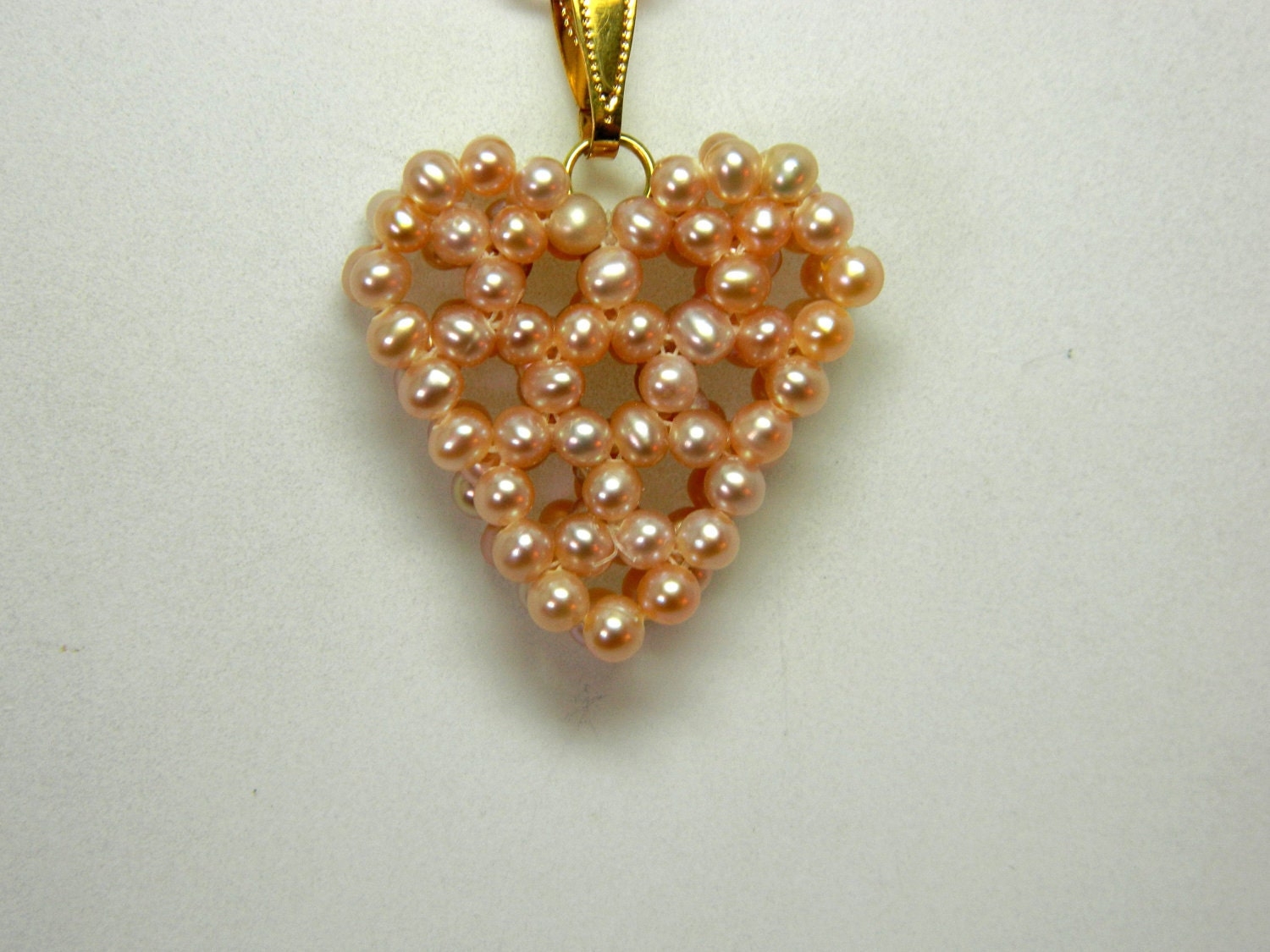 Heart shaped mauve seed pearl pendant with a  vermiel chain