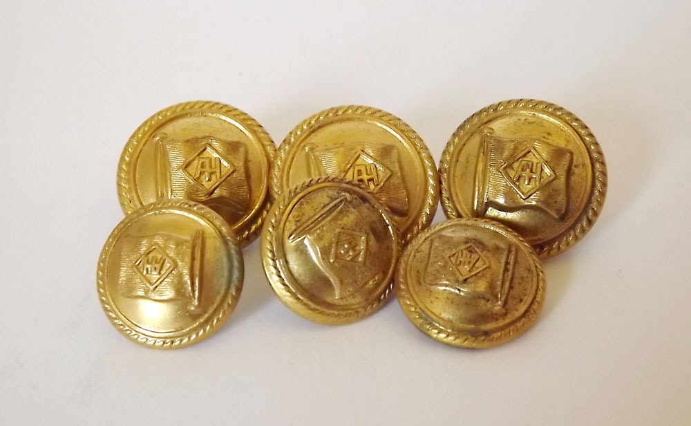 Six brass buttons in two sizes from a shipping line