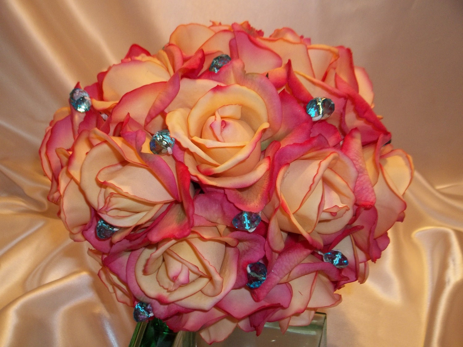 Shades of Coral Real Touch Roses Wedding Bouquet with Either Large or Smaller Teal Crystal Accents and Satin Hand Tied Stems.