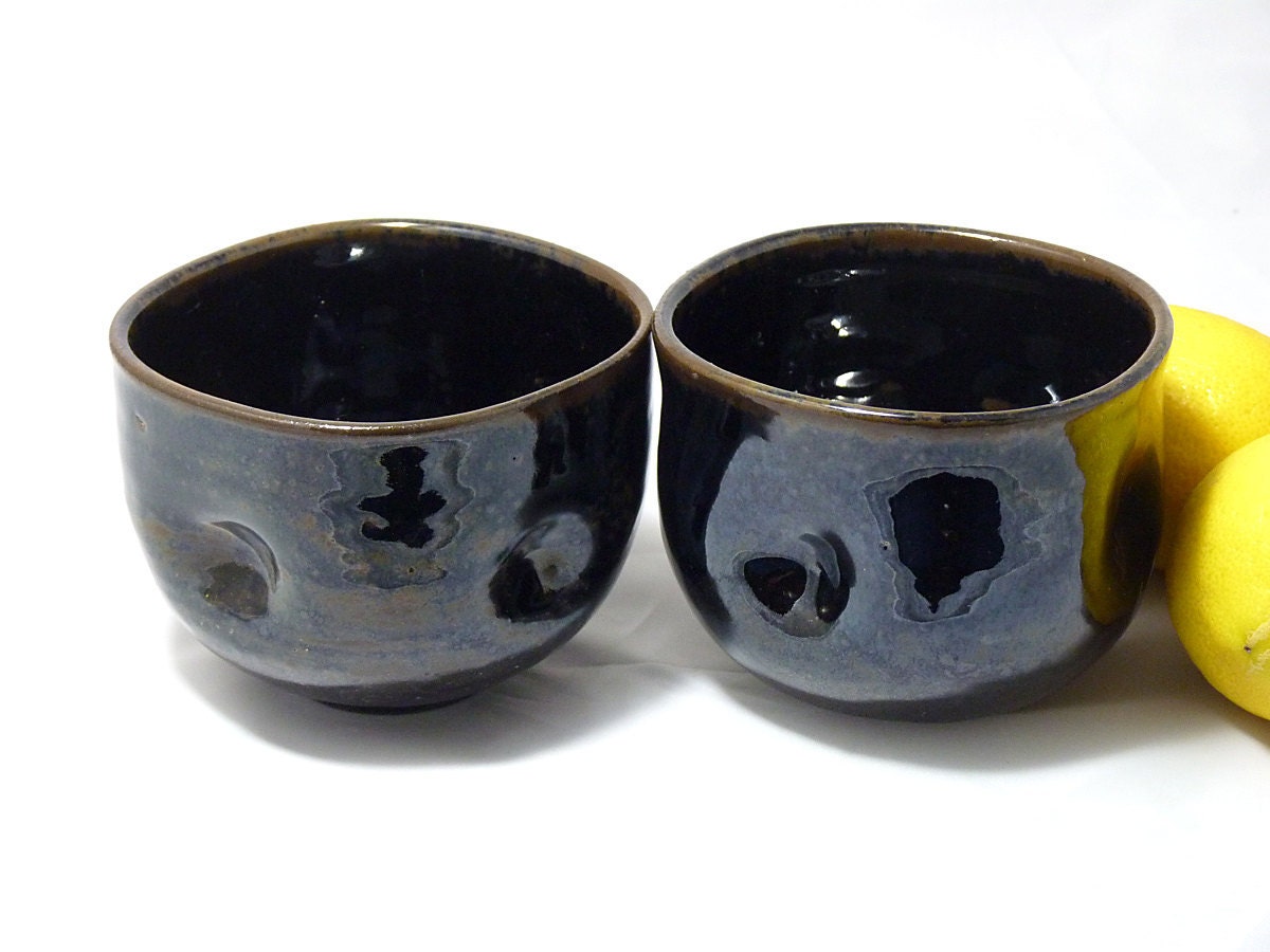Two beautiful black clay tea bowls / cups