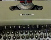 Leonard Cohen had a Olive colored, black keys Olivetti Lettera 22 manual typewriter with case