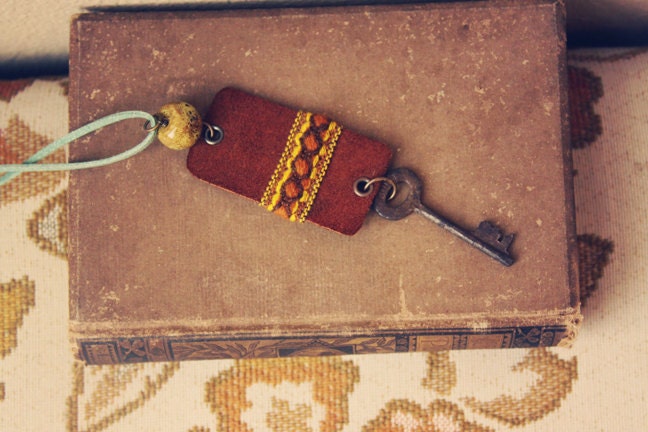 jade.  a bohemian necklace made of leather, stone, textile and a rusty key.