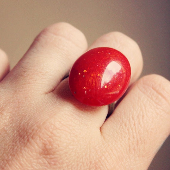 ruby.  a bronzy red colored cab ring with a hint of glitter.