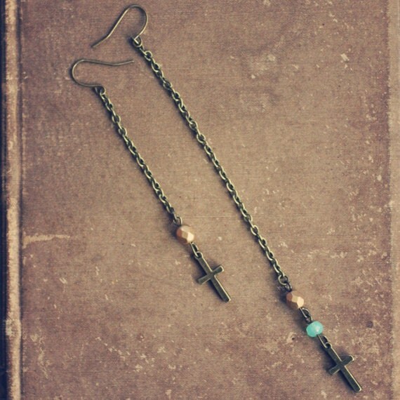 florence.  a pair of assymetrical cross earrings.