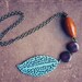 noel. a long earthy beaded wooden leaf necklace in cream.