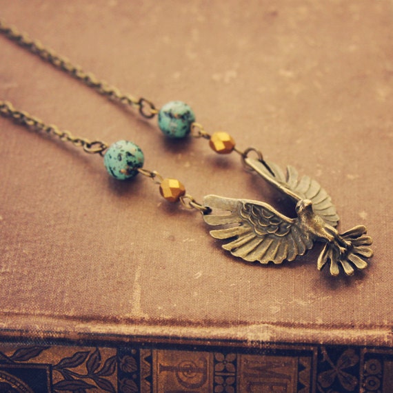 RESERVED FOR NAVIWING skylar.  a beaded brass bird in flight necklace.