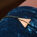emmalye.  a copper and gold geometric arrow necklace.