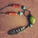 sioux. a colorful beaded brass feather necklace.