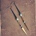 catori. a pair of long teal and brass spike earrings.