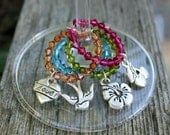 Four Wine Charms - Swarovski crystals with a vintage tatoo theme - hibiscus flower, love, sparrow, and cherries