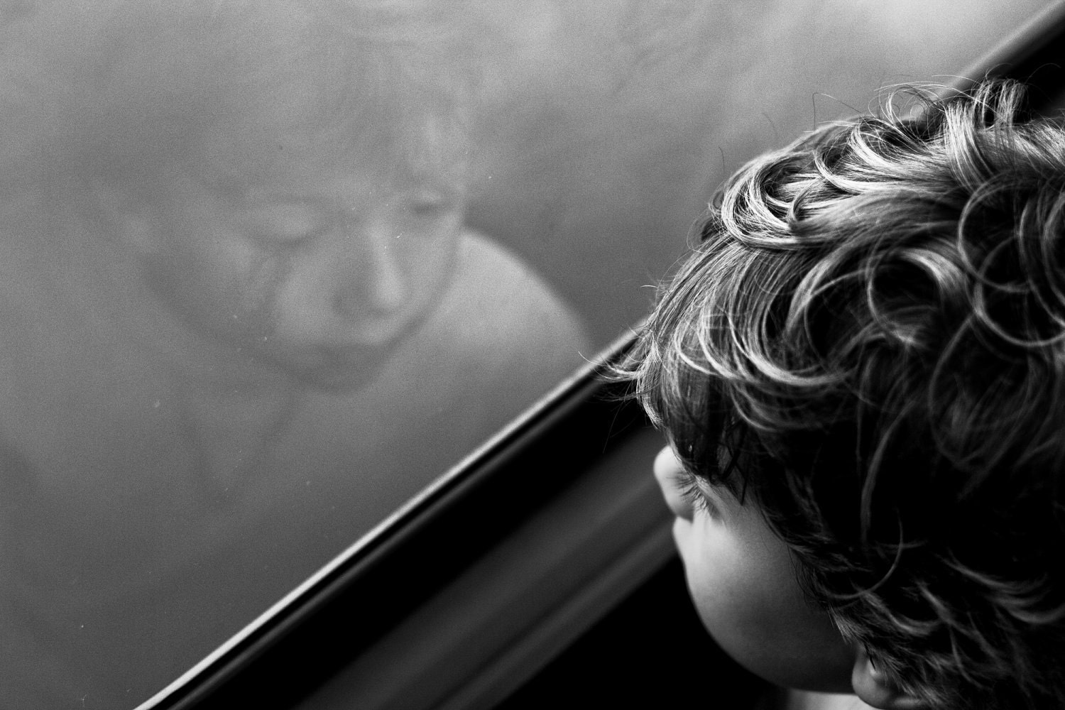 The Boy that Stayed - Signed Archival Fine Art Print - Black and White Photography by Sabato Visconti - Silver Tone Child Portrait in Train - Sabatobox