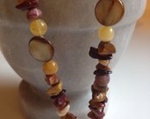 Natural stone and shell lanyard badge Id holder burgundys, greens, browns and tans are combined with a shell and stone beads