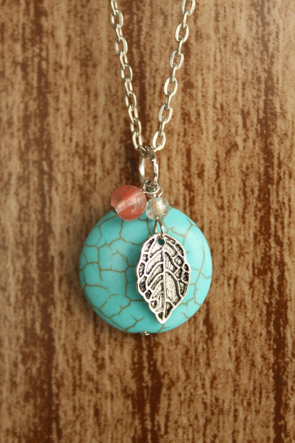 Turquoise Round Stone Necklace with Coral Bead and Silver Leaf Charm