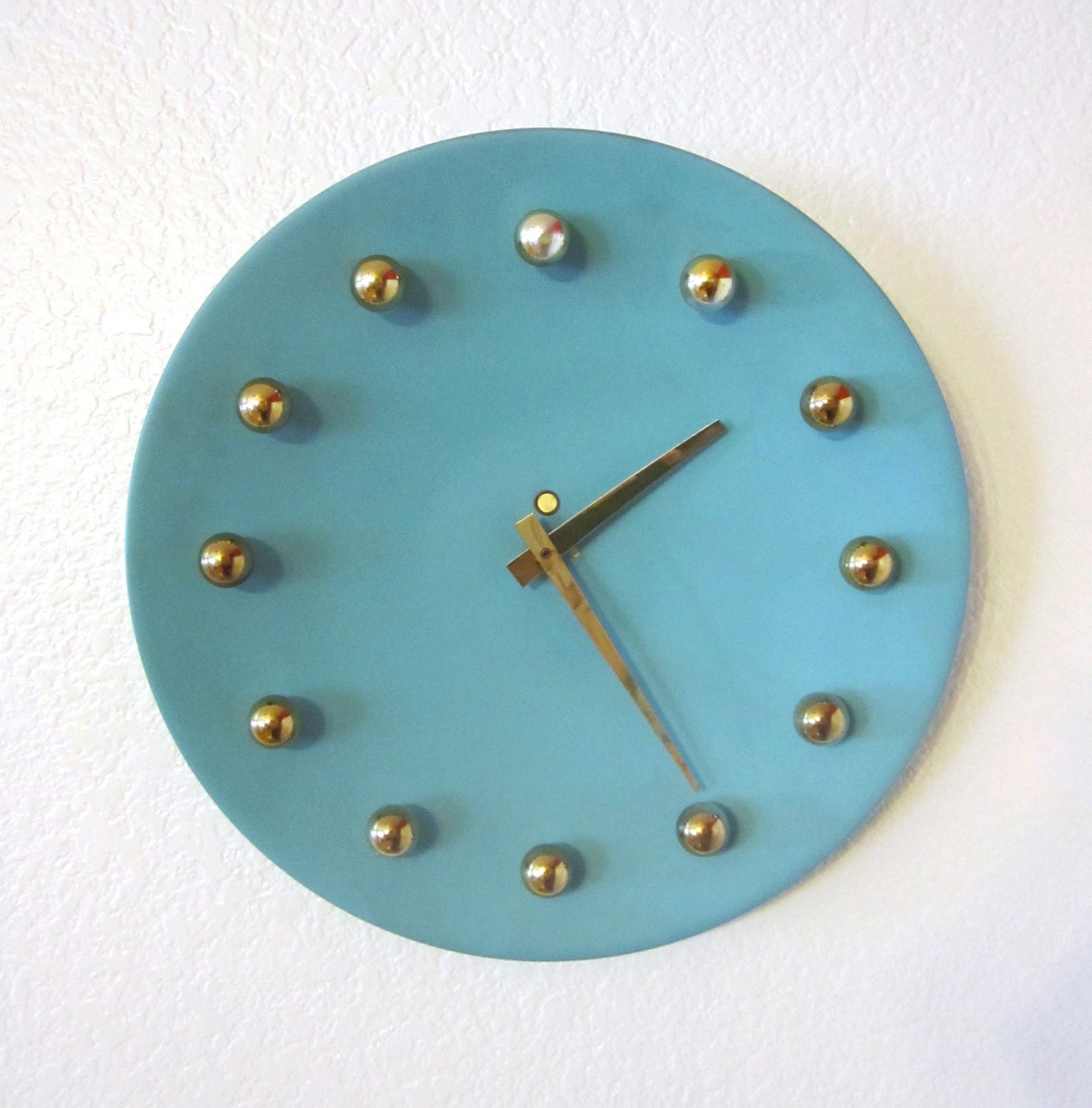 Atomic Metal Wall Clock in Aqua and Gold