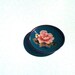 Vintage miniature blue metal and enamel plate featuring a rose