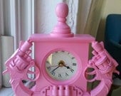 pink nonfunctional gun clock