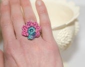 Flower Ring, Pink with a touch of teal, crocheted, adjustable