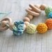 Teething toy rattle with crochet wooden beads and 3 wooden rings. Yellow, orange, light green, aqua blue/ cyan.
