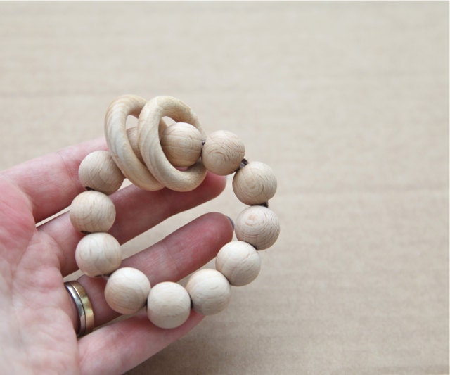 Teething ring toy with wooden beads and 2 wooden rings. Neutral waldorf wooden beads rattle.