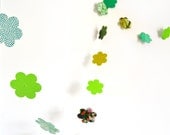 Green garland in cardboard flowers