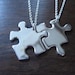 Two Silver Puzzle Piece Pendants