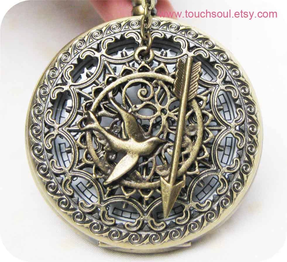 The Hunger Games Inspired Arrow with Mockingjay and Peeta Pearl heart spider web pocket watch locket necklace