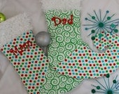 Personalized Christmas stocking with red and green polka dots and swirls