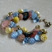 Vintage button bracelet glass, metal and plastic buttons in pink, yellow, blue and black hearts and flowers