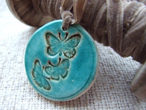 Butterfly pendant, bronze and turquoise crackle glaze, tied with a butterscotch vintage velvet ribbon